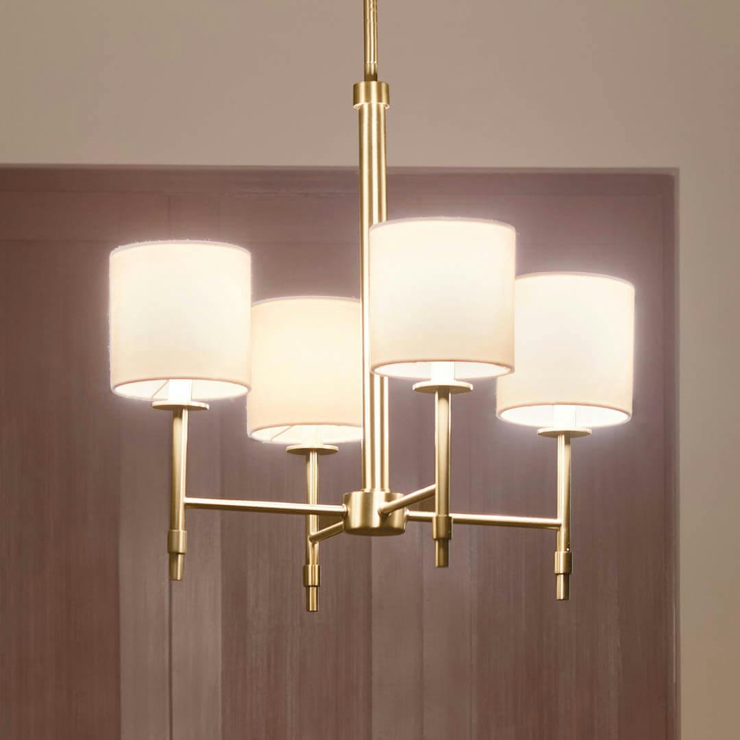 Night time dining room with Ali 20" 4 Light Chandelier Brushed Natural Brass