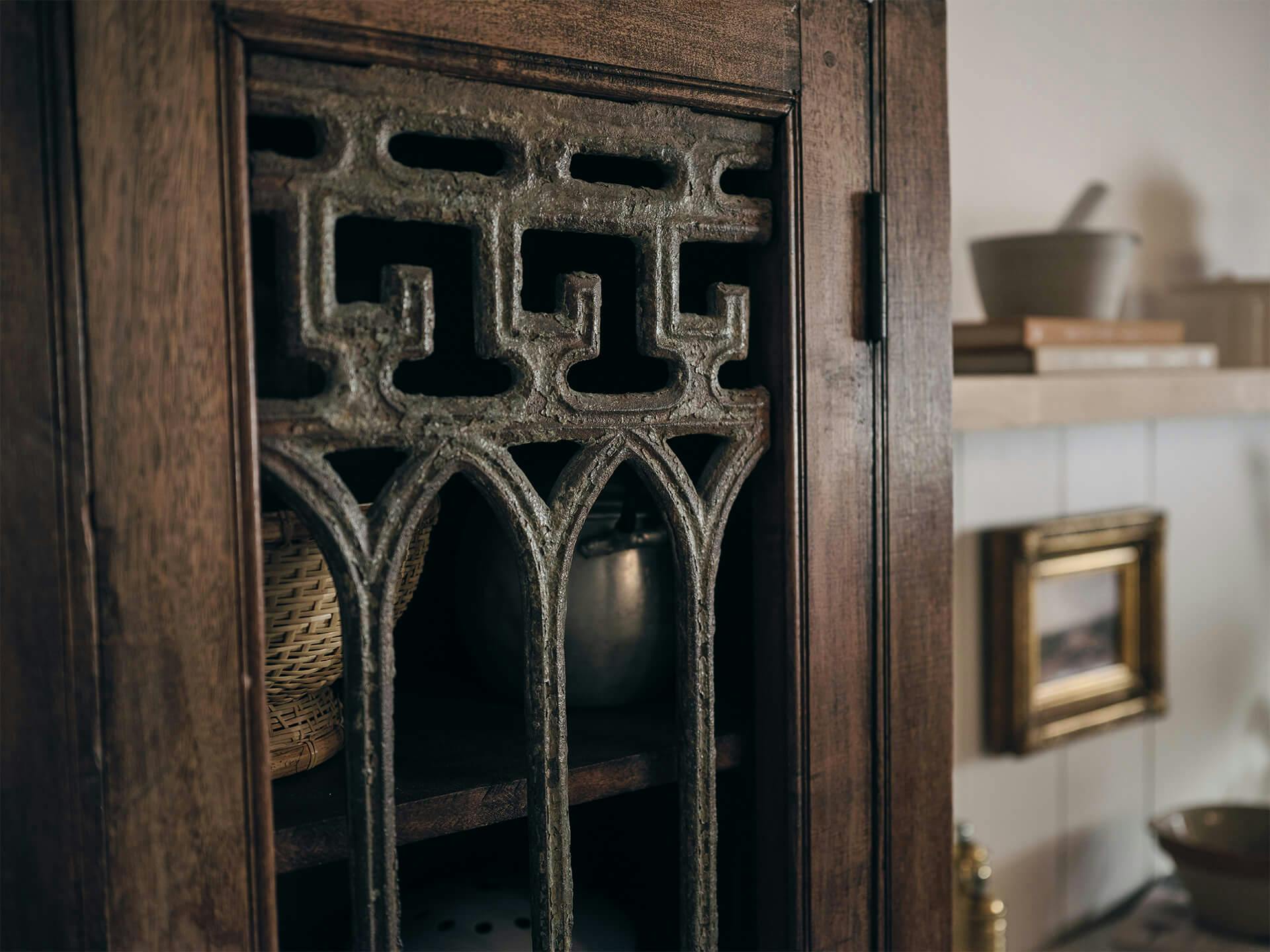 Detail shot of a cabinet with vintage metal detailing 
