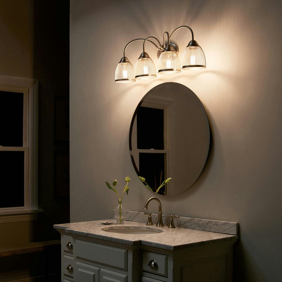 Nighttime Bathroom featuring Voclain vanity light 55044NI