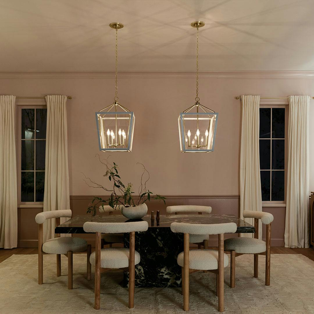 Night time dining room with the Delvin 24 Inch 4 Light Pendant with Clear Glass in Champagne Bronze and White