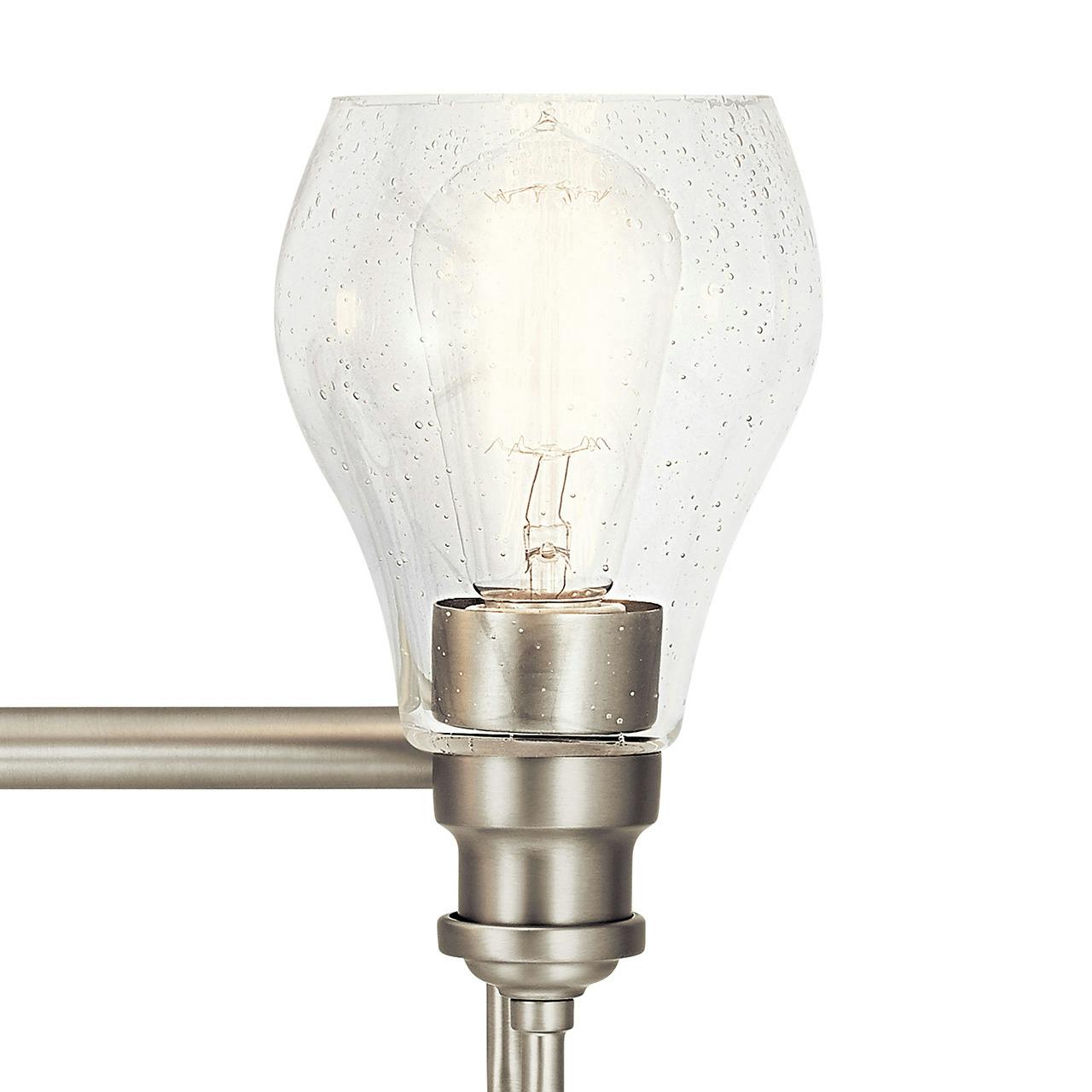 Close up view of the Greenbrier™ 3 Light Vanity Light Nickel on a white background