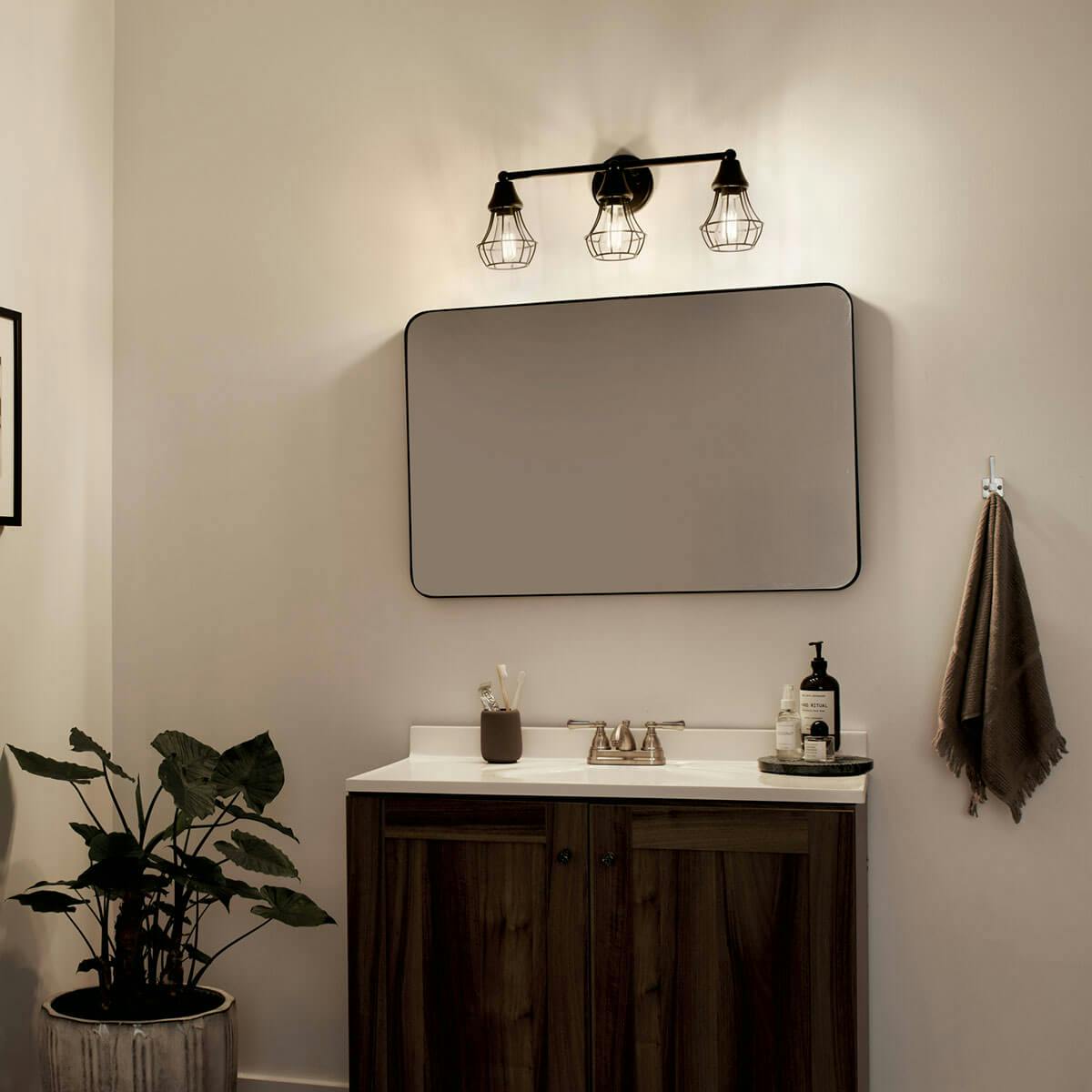 Night time Bathroom featuring Bayley vanity light 37510BK