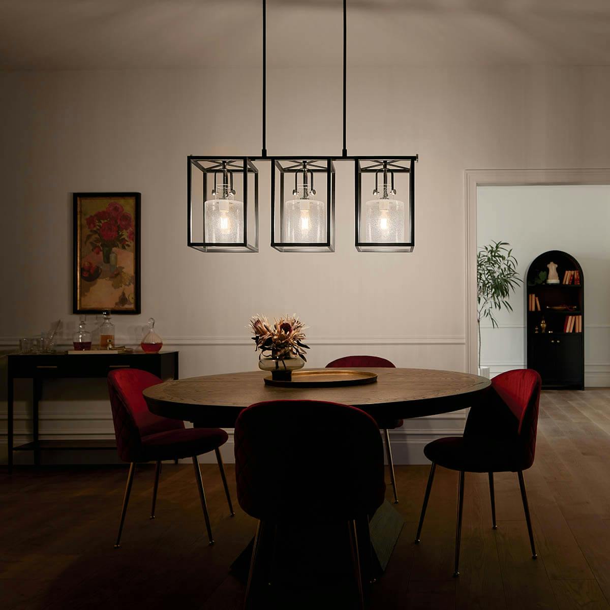 night time dining room with Kitner 3 light chandelier Polished Nickel