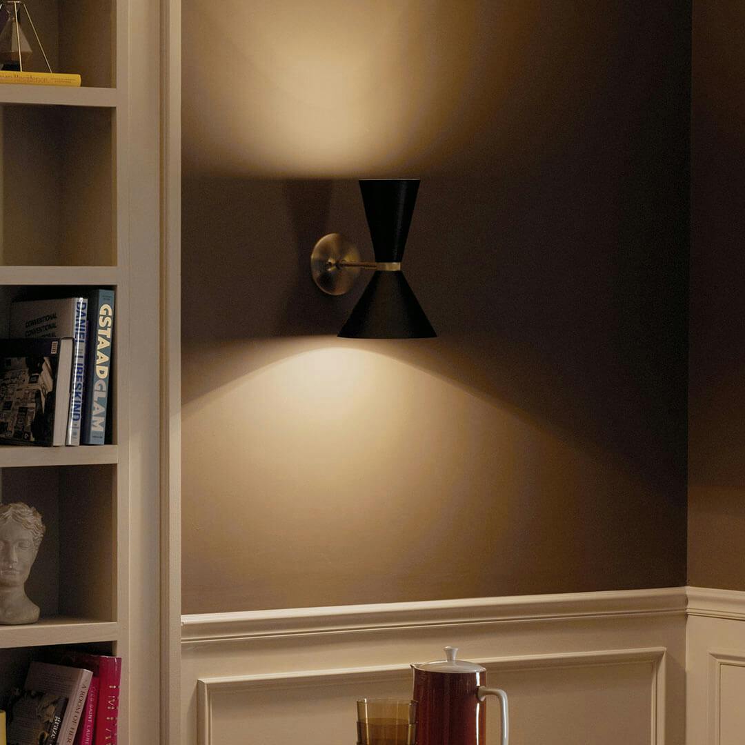 Night time dining room with the Phix 13.5 Inch 2 Light Wall Sconce in Champagne Bronze with Black