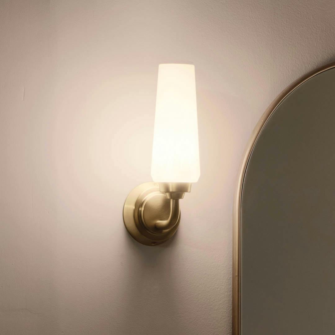 Night time bathroom with Truby 11.5 Inch 1 Light Wall Sconce with Satin Etched Cased Opal Glass in Champagne Bronze
