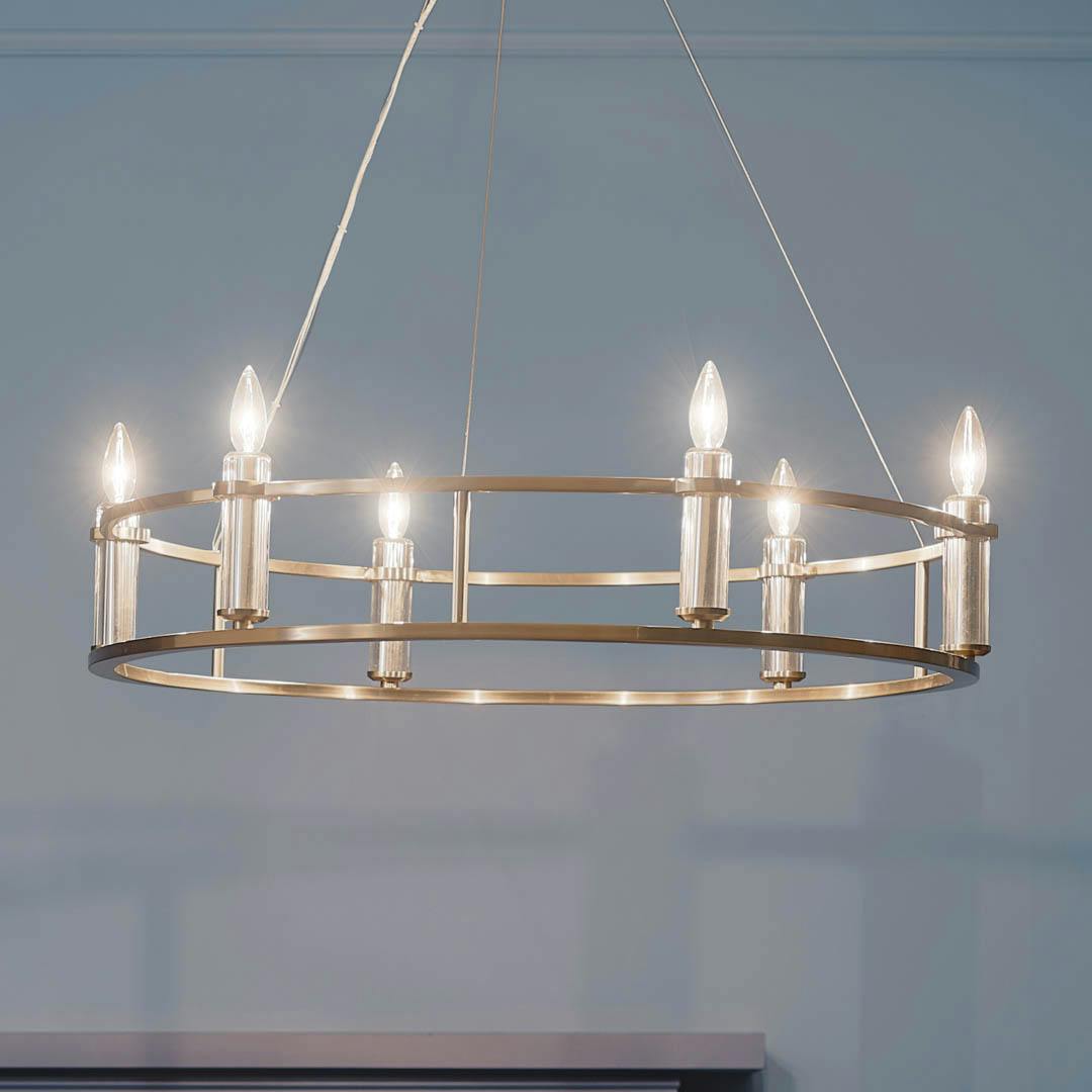 Night time dining room with Rosalind 33.25" 6 Light Chandelier Brushed Natural Brass