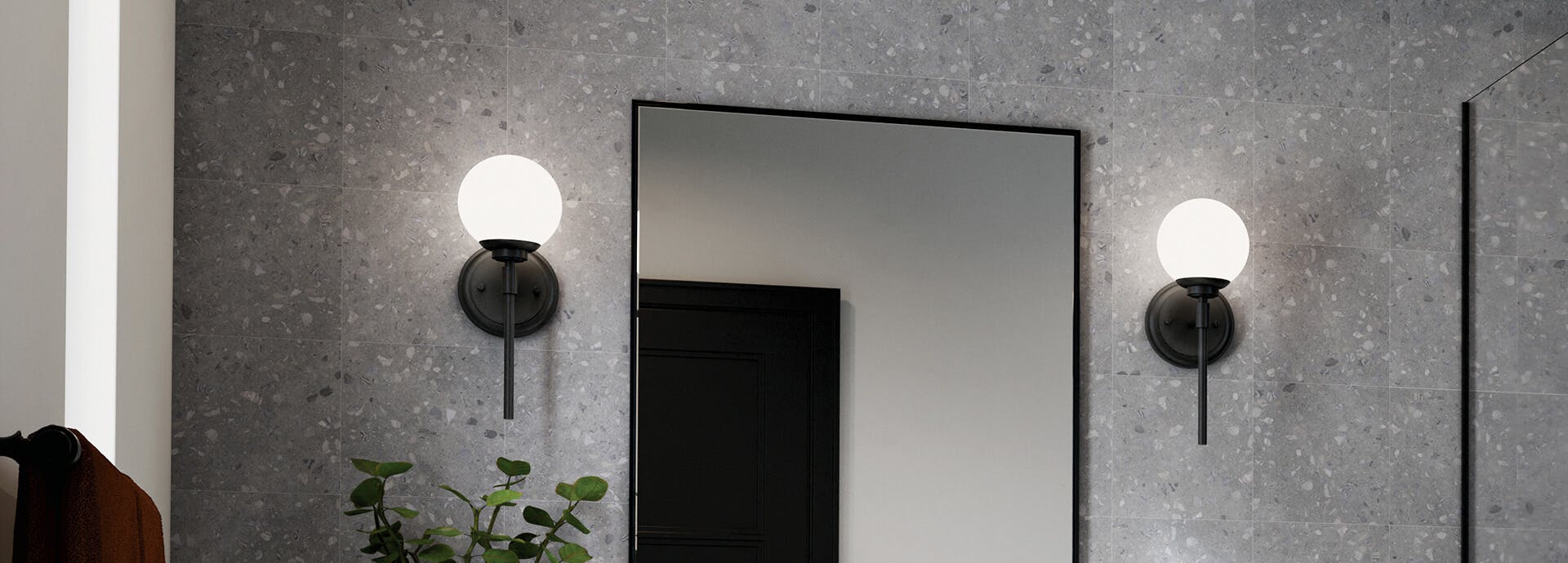 Benno wall sconces on either side of a mirror in a modern bathroom