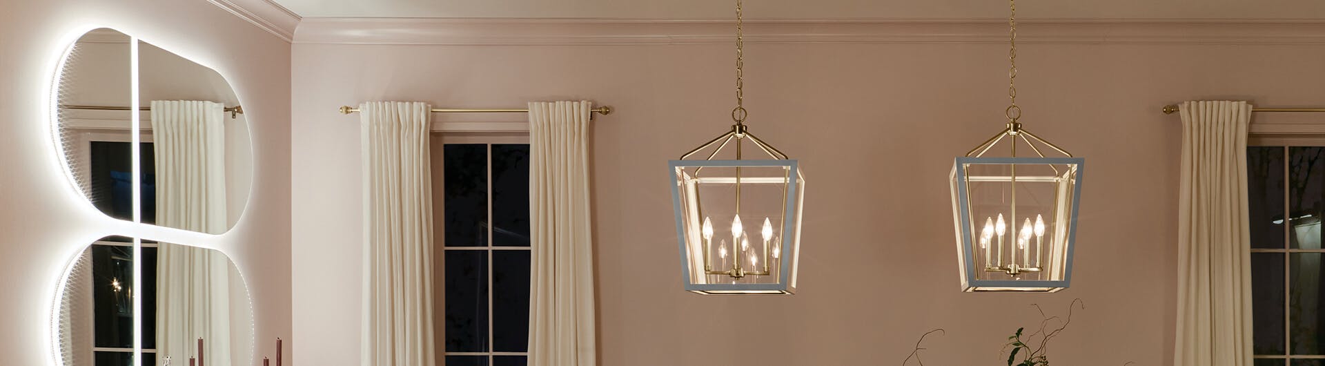 Two lit Delvin pendants in champagne bronze and white hanging in a room