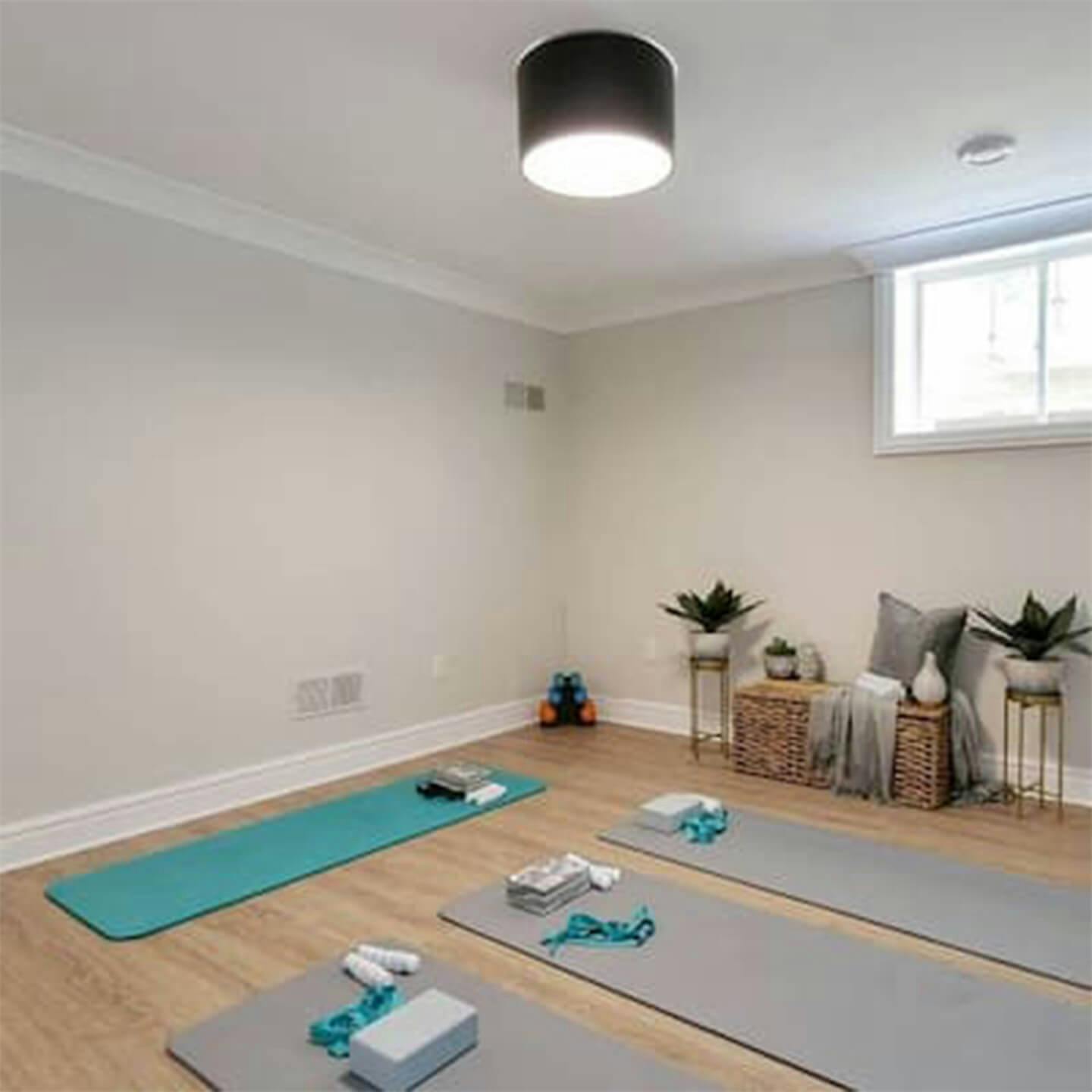 A room with 3 student yoga mats and 1 instructor yoga mat laid out