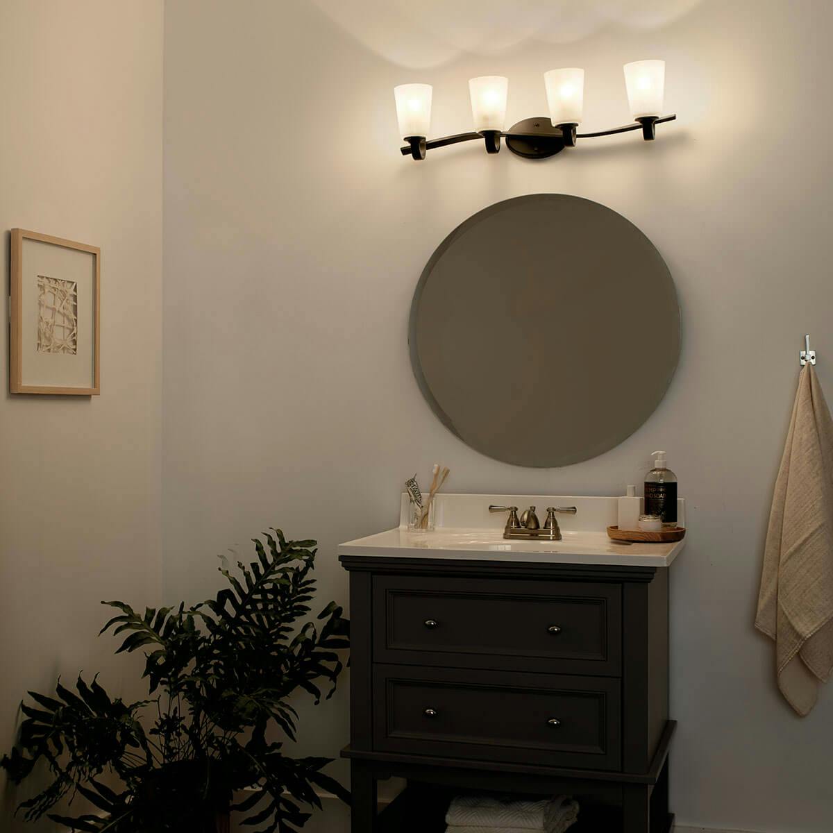 Night time Bathroom featuring Oxby vanity light 37520OZ