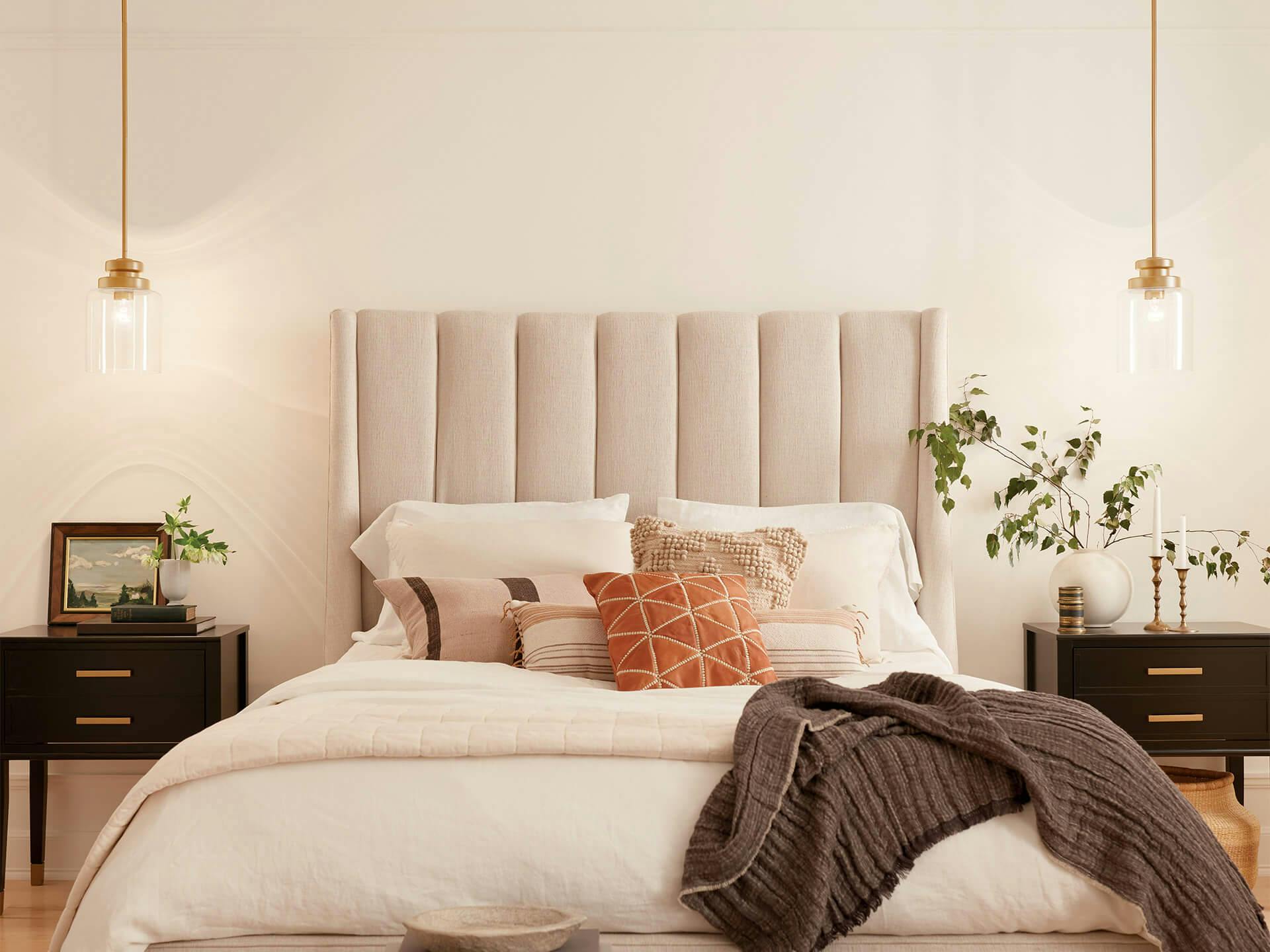 Bedroom with gold Annabeth pendants during the day