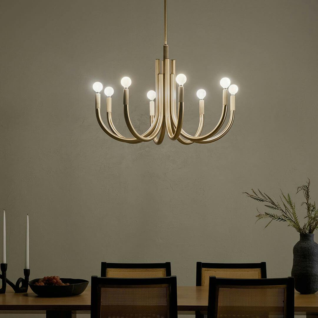 Night time dining room with the Odensa 29.25 Inch 8 Light Chandelier in Champagne Bronze