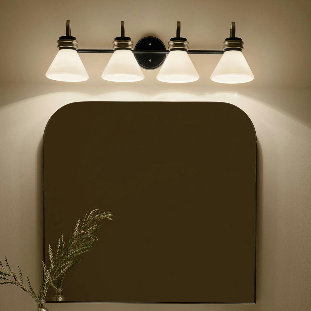 Night time bathroom with the Farum 34 Inch 4 Light Vanity with Opal Glass in Black with Champagne Bronze