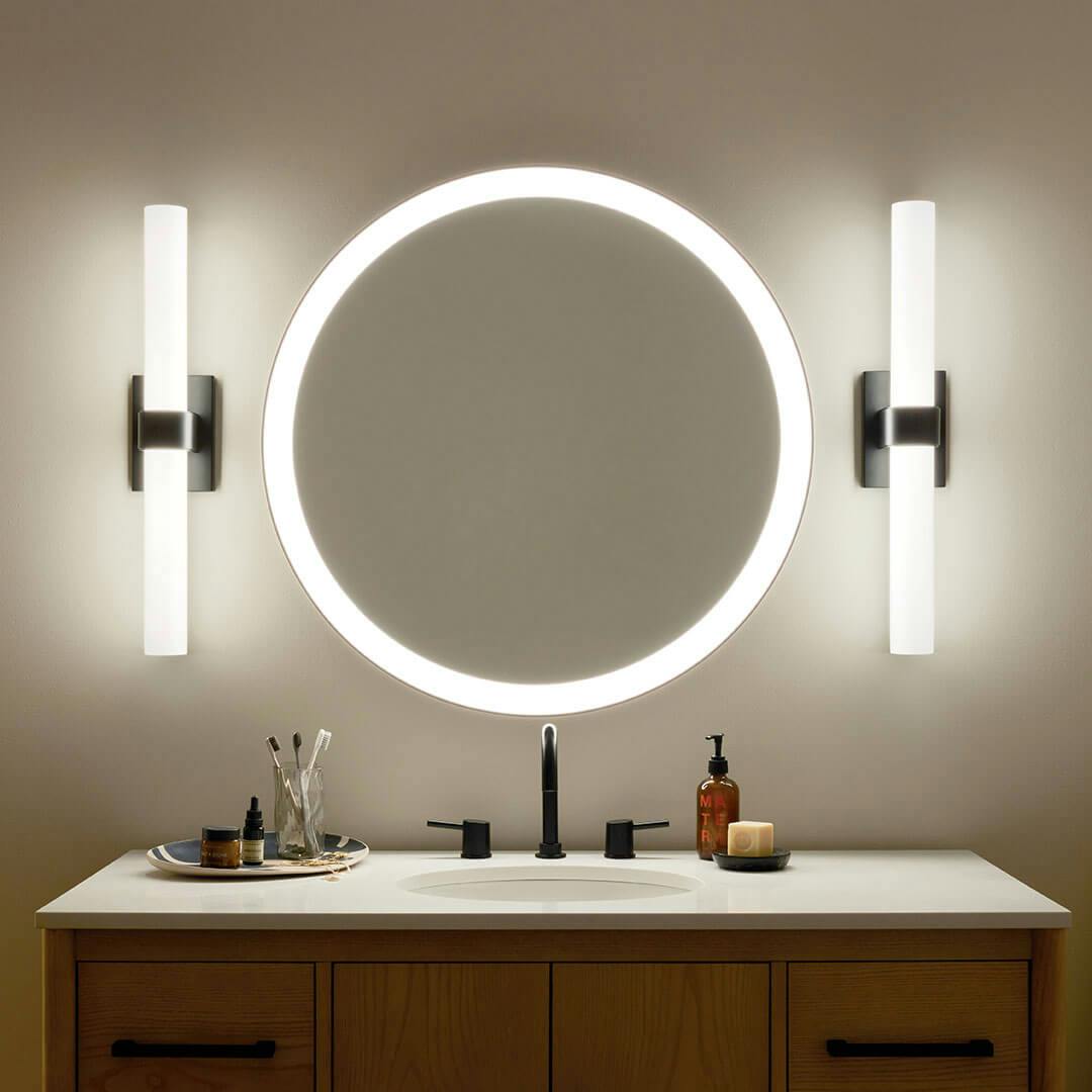 Bathroom in the night time with the Izza 25.5 Inch LED Linear Bath Light in Matte Black