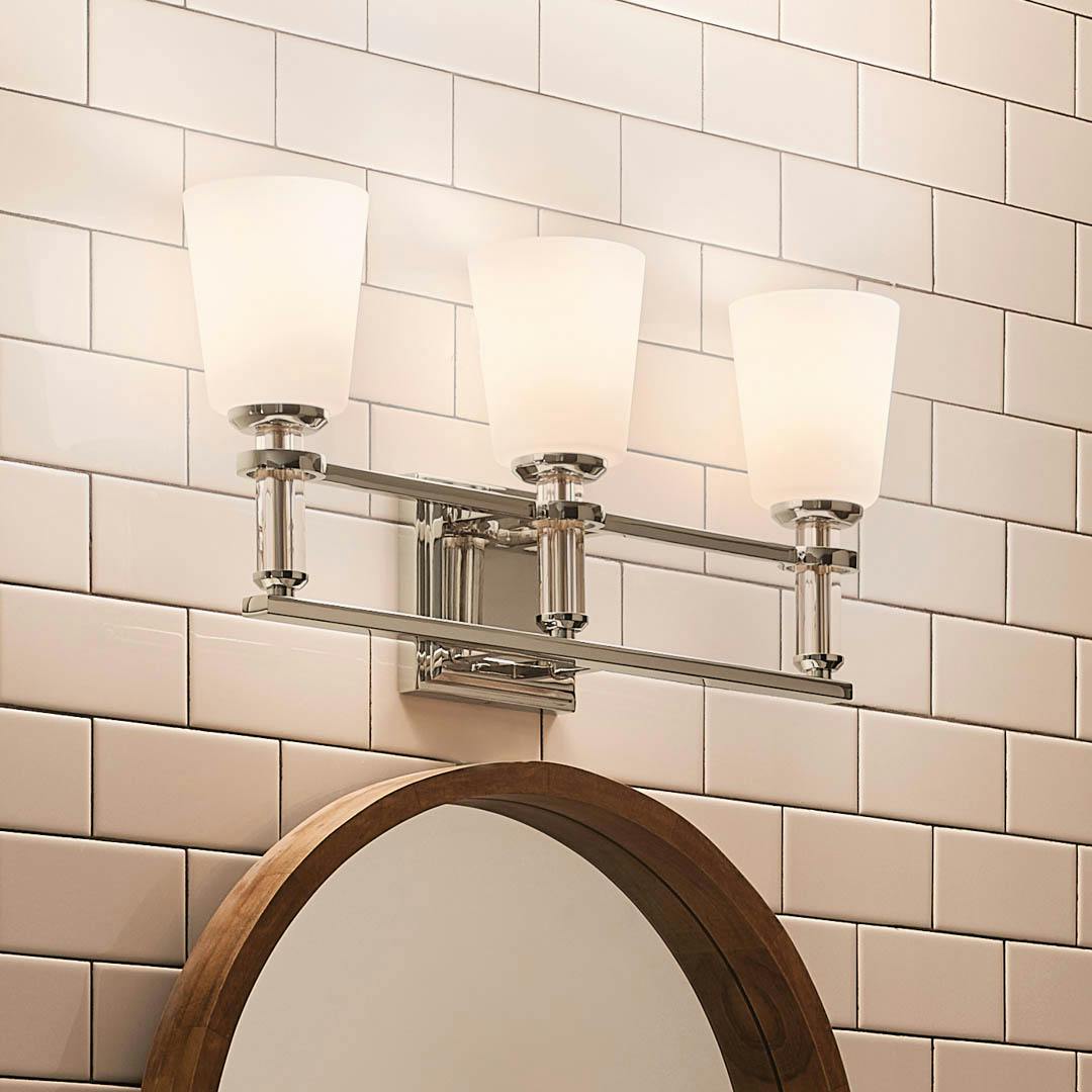 Night time bathroom with Rosalind 11.5" 3 Light Vanity Light Polished Nickel