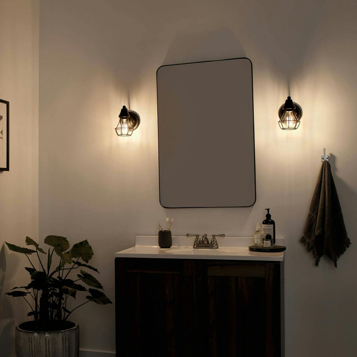 Night time Bathroom featuring Bayley vanity light 37512BK
