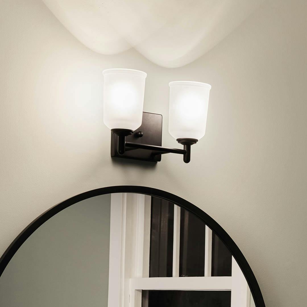 Night time bathroom with Shailene 12.75 inch 2 Light Vanity Light with Satin Etched Glass in Black