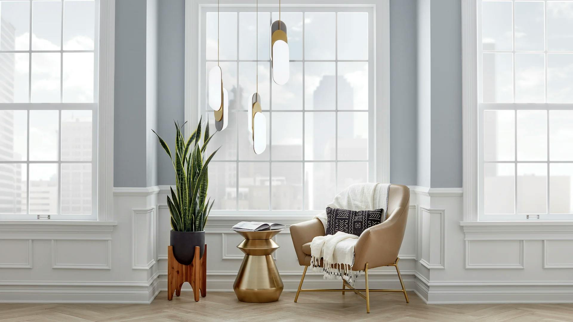 An inset window area with an accent chair, side table and plant featuring three shima pendants hanging above.