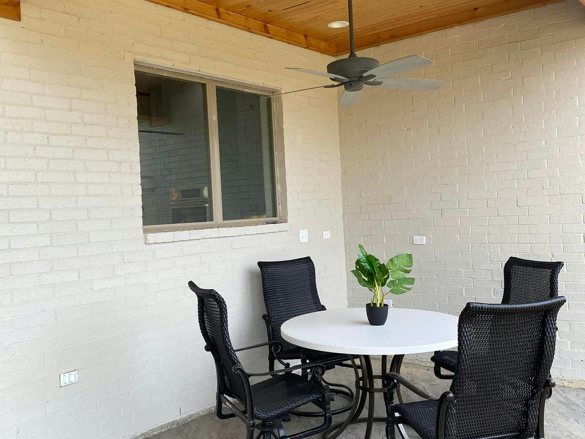 Patio with outdoor dining area and Kichler fan hanging above