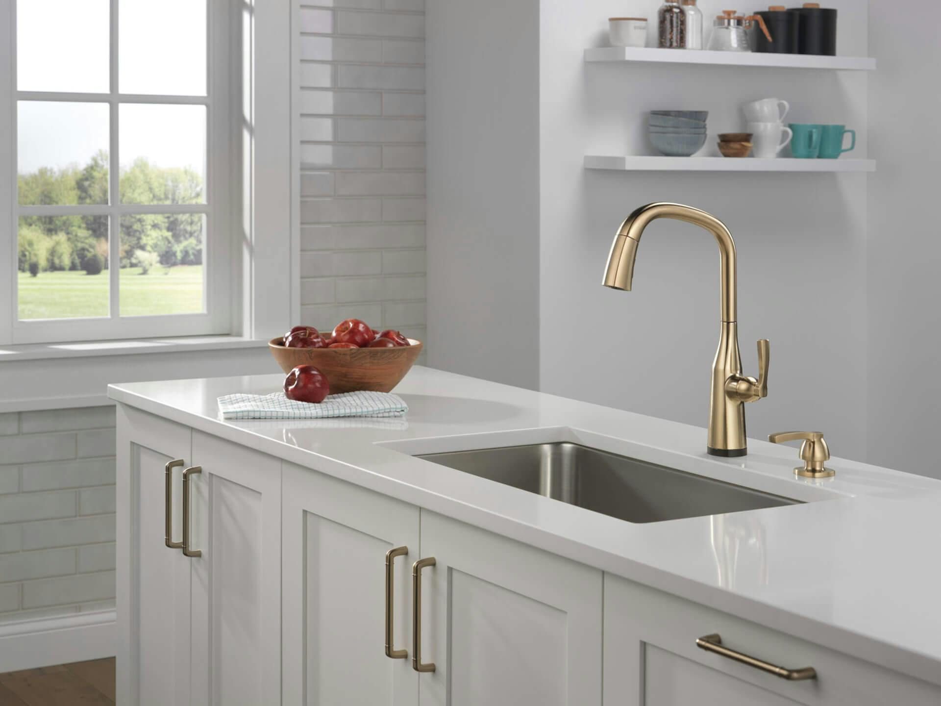 Kitchen island with a sink featuring a Delta Touch2O faucet in champagne bronze