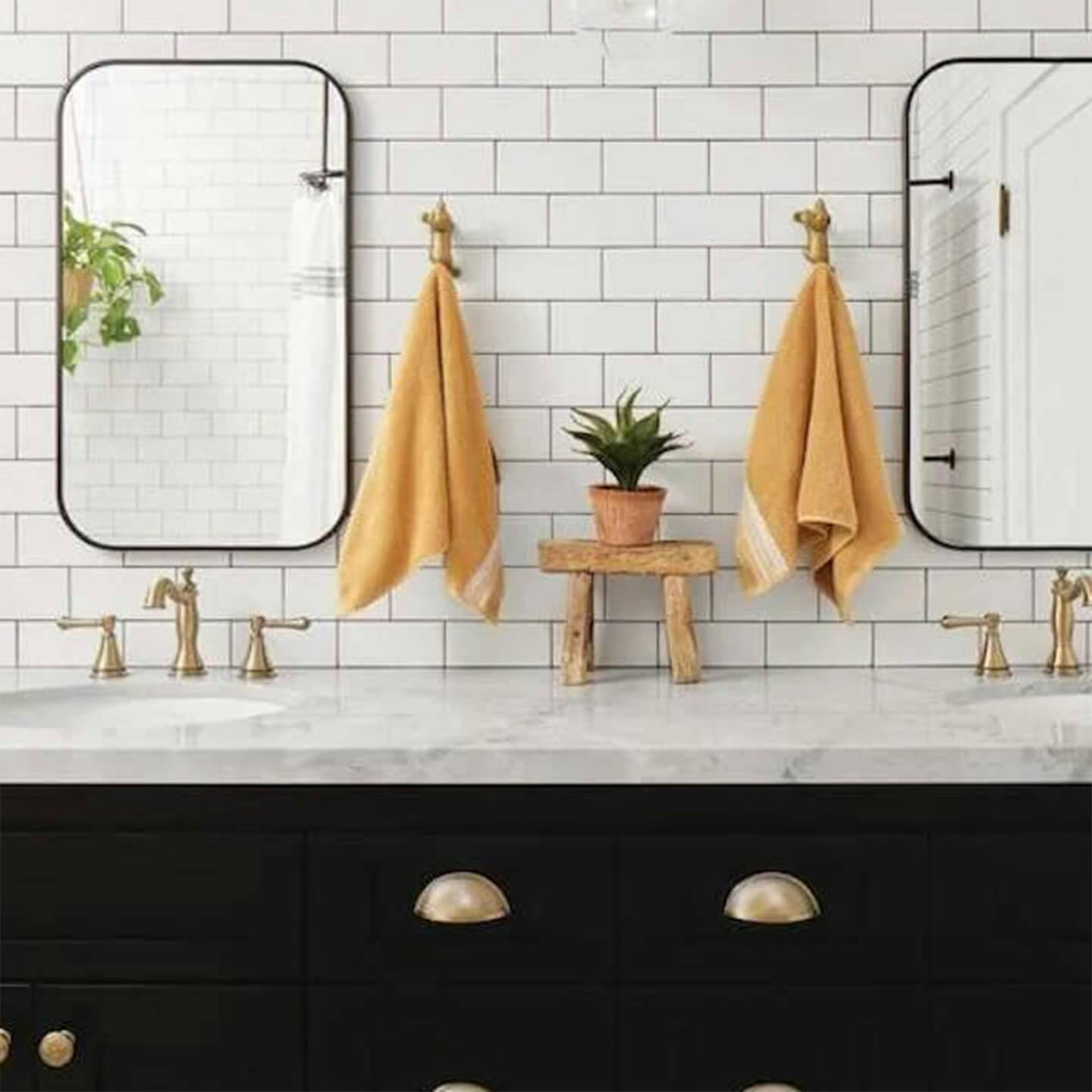 Subway tiled bathroom with champagne bronze details