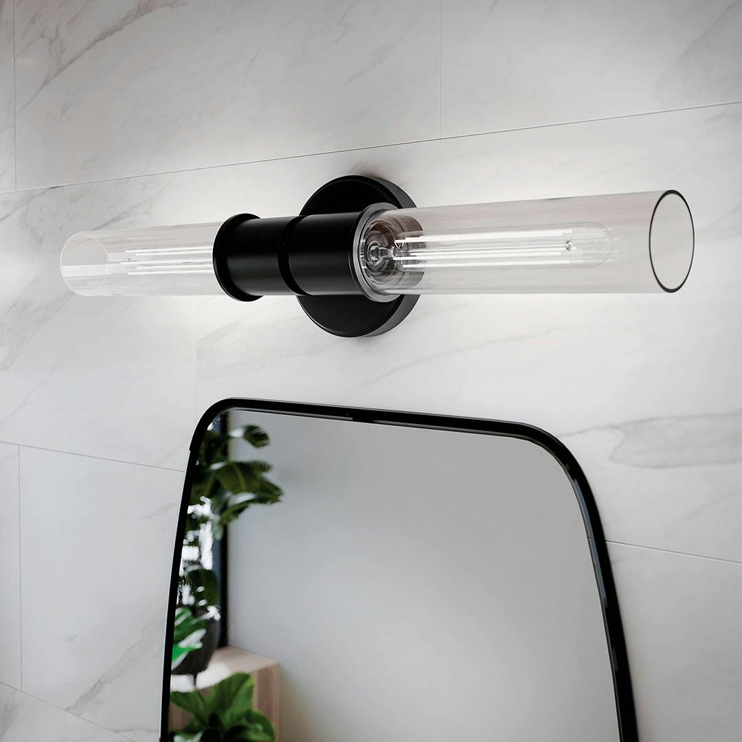 Bathroom in daylight with the Aviv 24 Inch 2 Light Wall Sconce with Clear Glass in Black