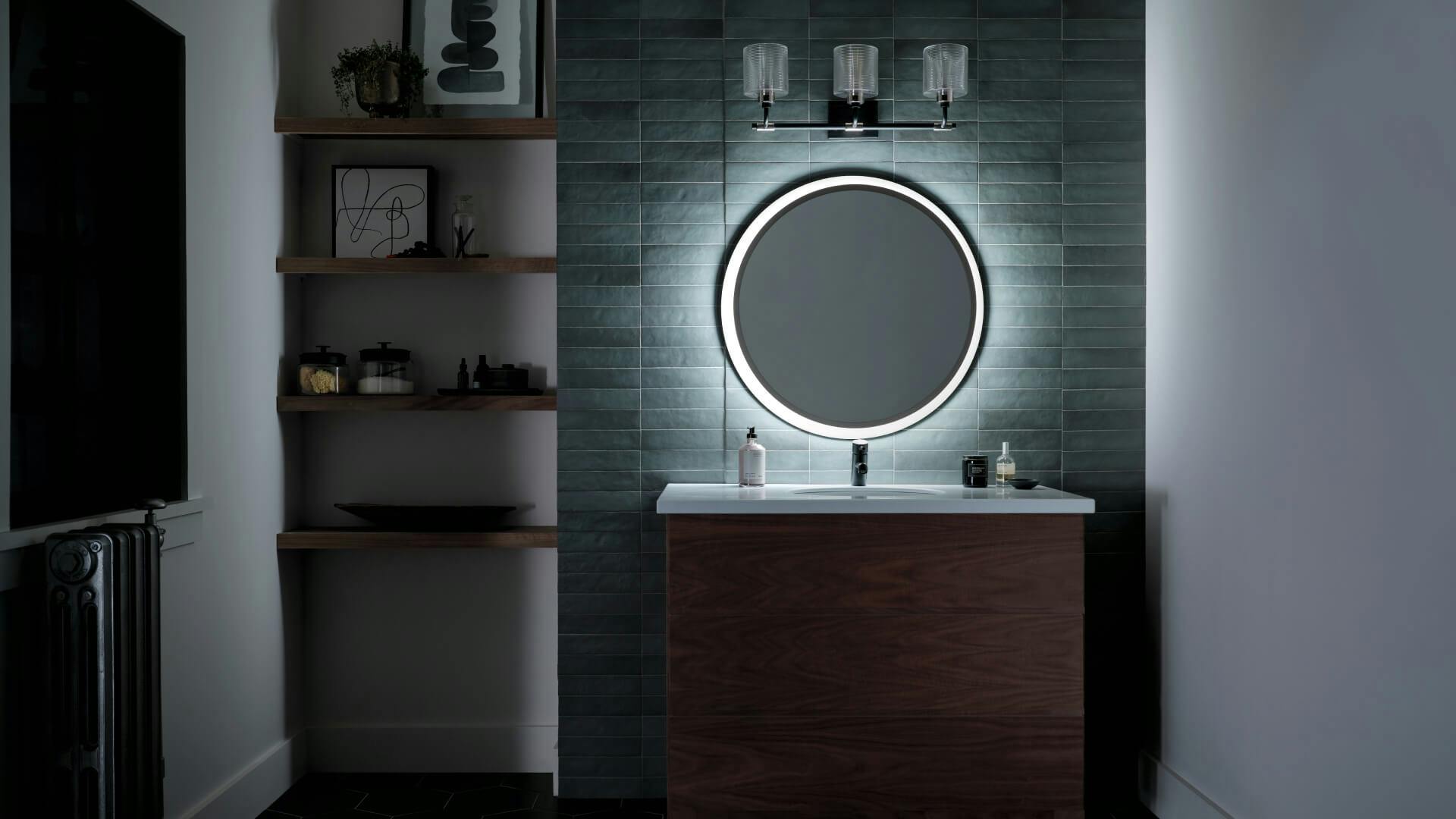 Modern bathroom lit with a Chenni mirror at night 