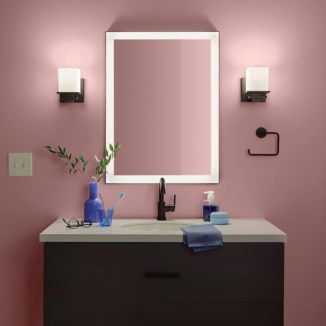 Bathroom at night with the Tully 6.5" 1-Light Wall Sconce in Black