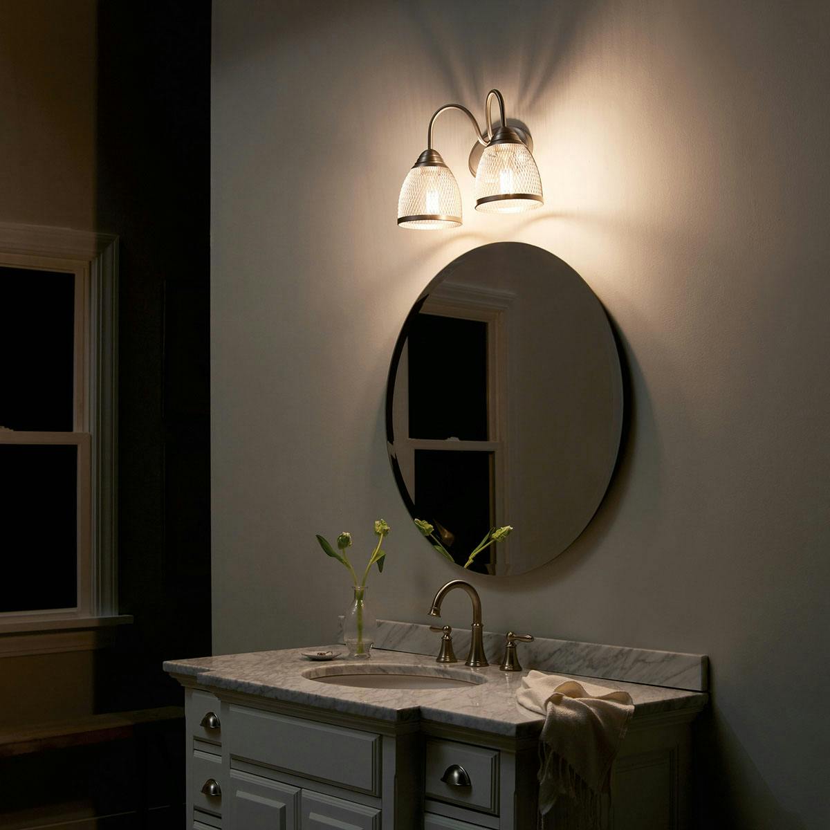 Nighttime Bathroom featuring Voclain vanity light 55042NI