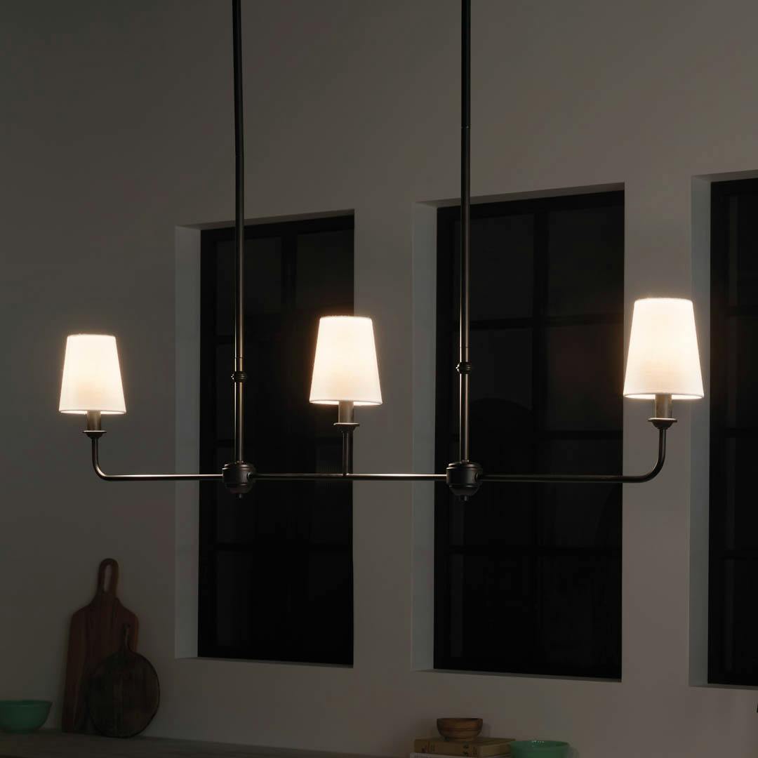 Night time kitchen with Pallas 48.25" 3 Light Linear Chandelier Black