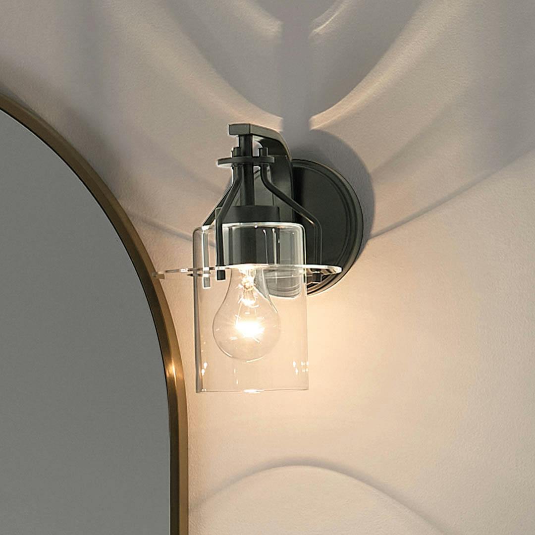 Night time bathroom with Everett™ 9.25" 1 Light Wall Sconce Black