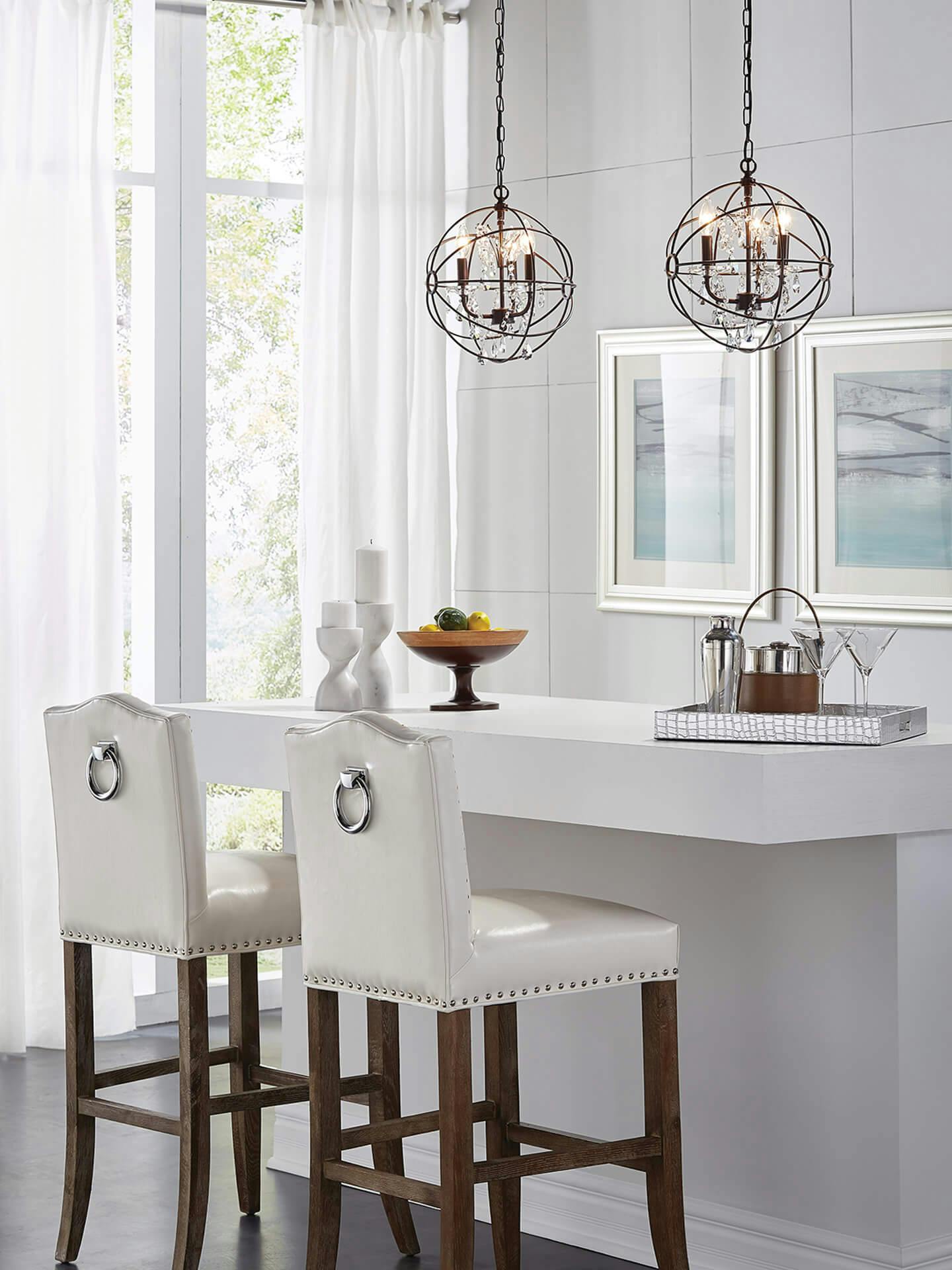 All white kitchen table featuring Vivian pendant lamps.