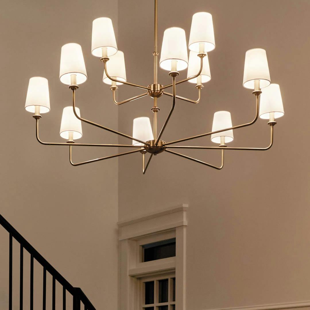 Night time foyer with Pallas 42.75" 12 Light Chandelier Brushed Natural Brass