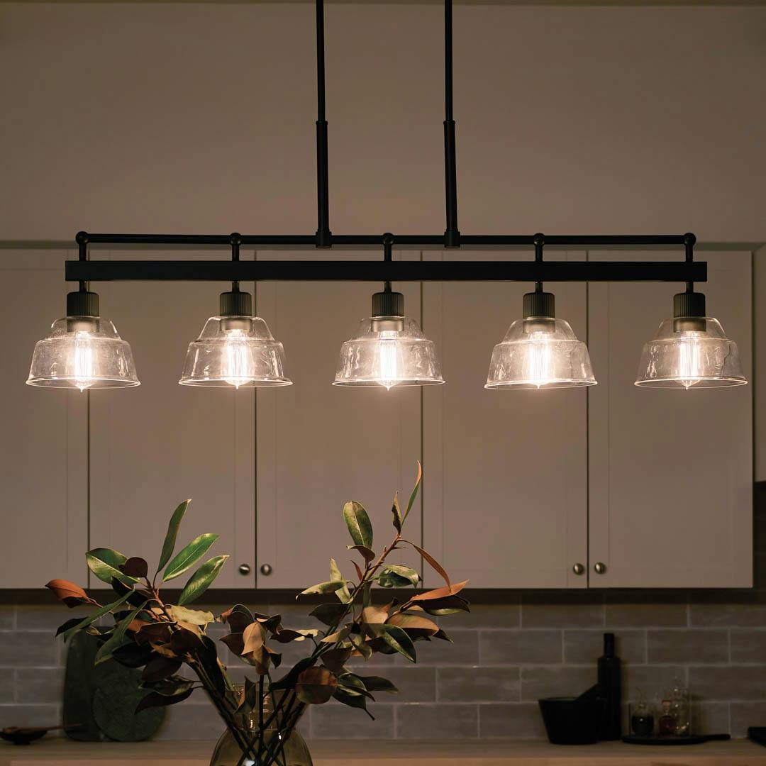 Night time kitchen with Eastmont™ 5 Light Linear Chandelier Black  and Walnut Wood