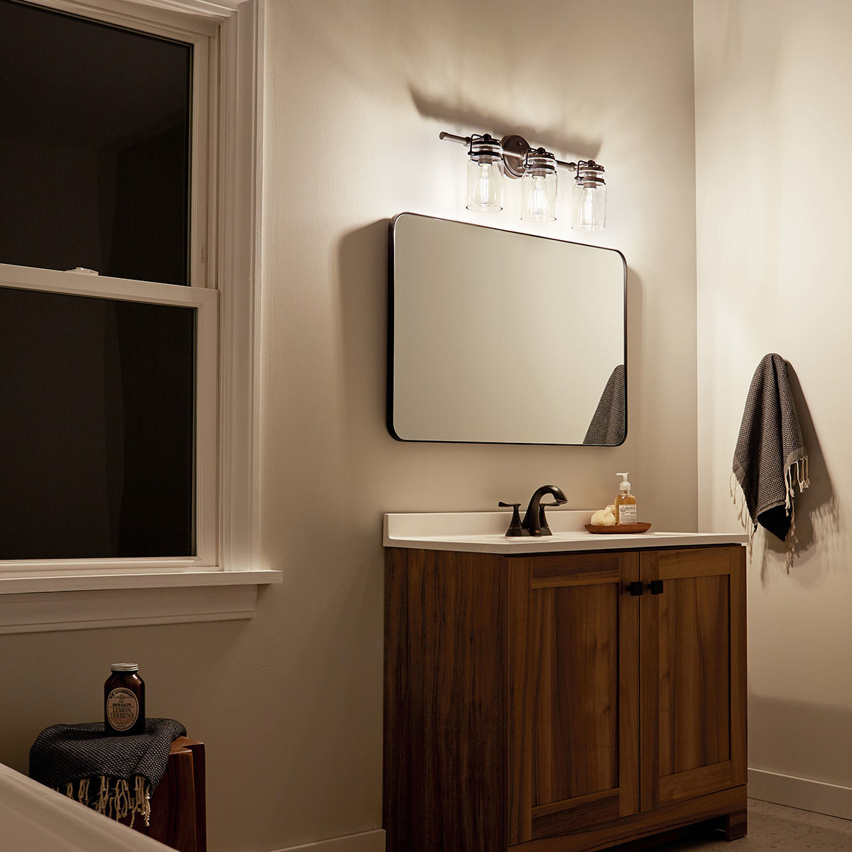 Night time Bathroom featuring Brinley vanity light 45689OZ