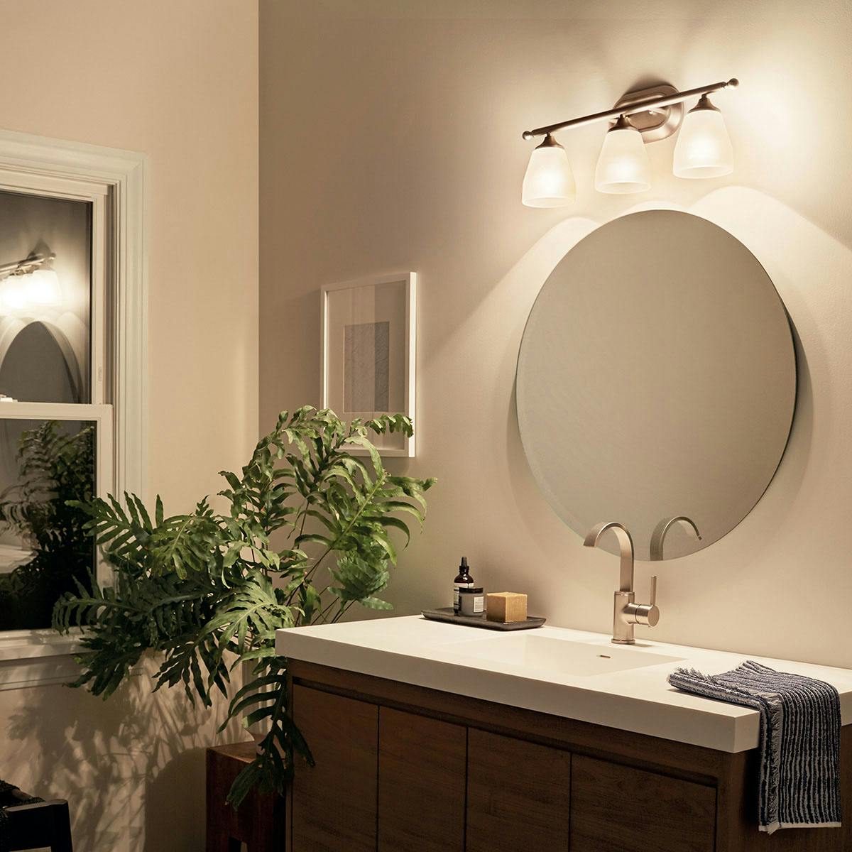 Night time Bathroom featuring Ansonia vanity light 5448NI