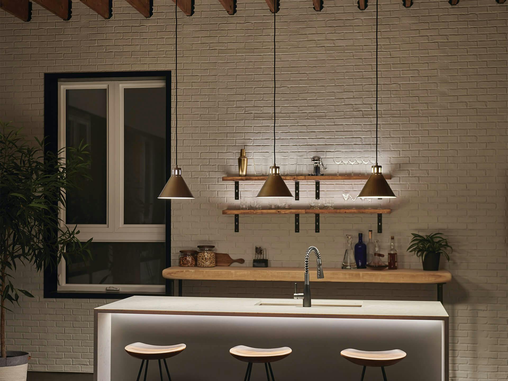 Indoor modern home bar at night featuring Zailey pendant lines.