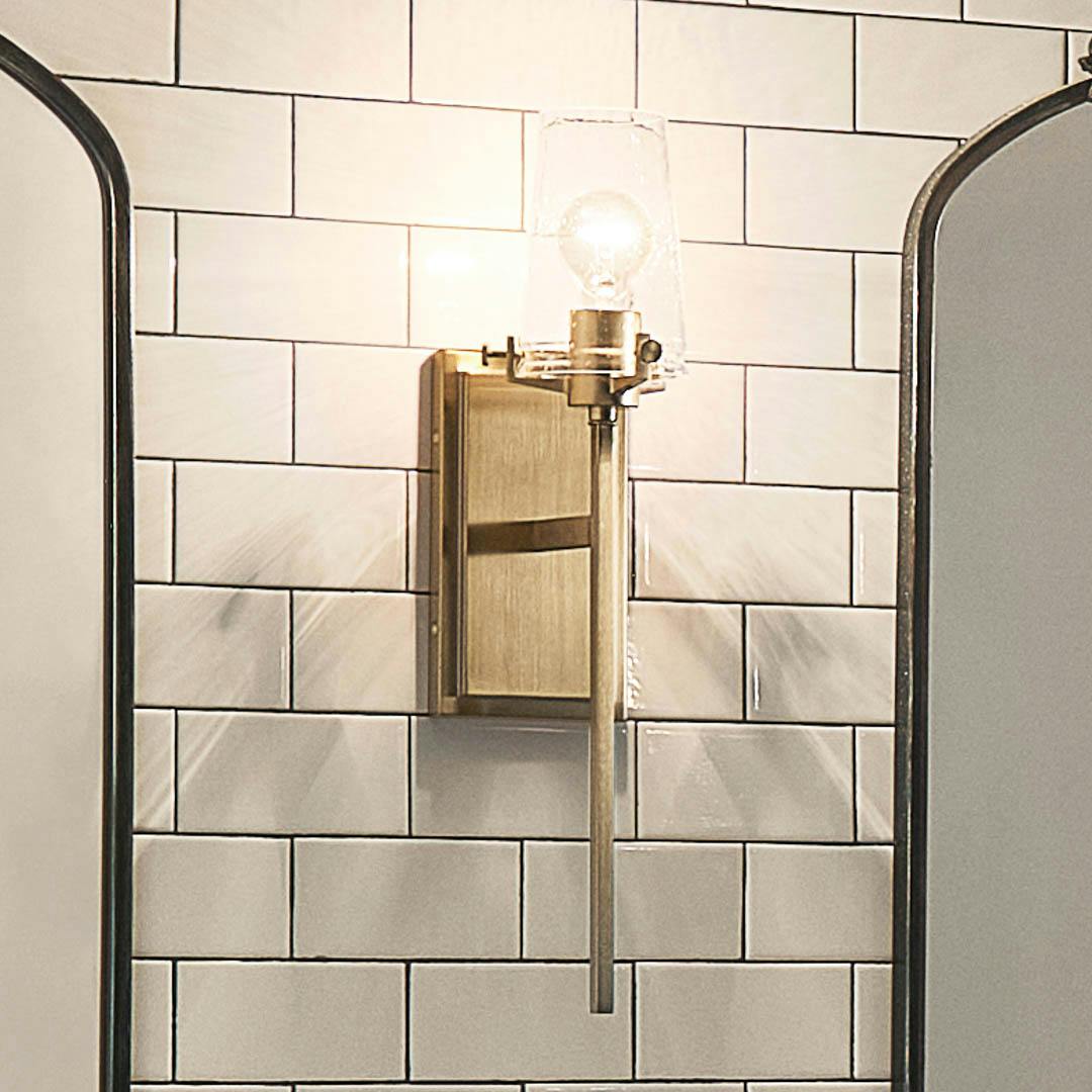 Night time bathroom with Alton 22" 1 Light Wall Sconce Champagne Bronze