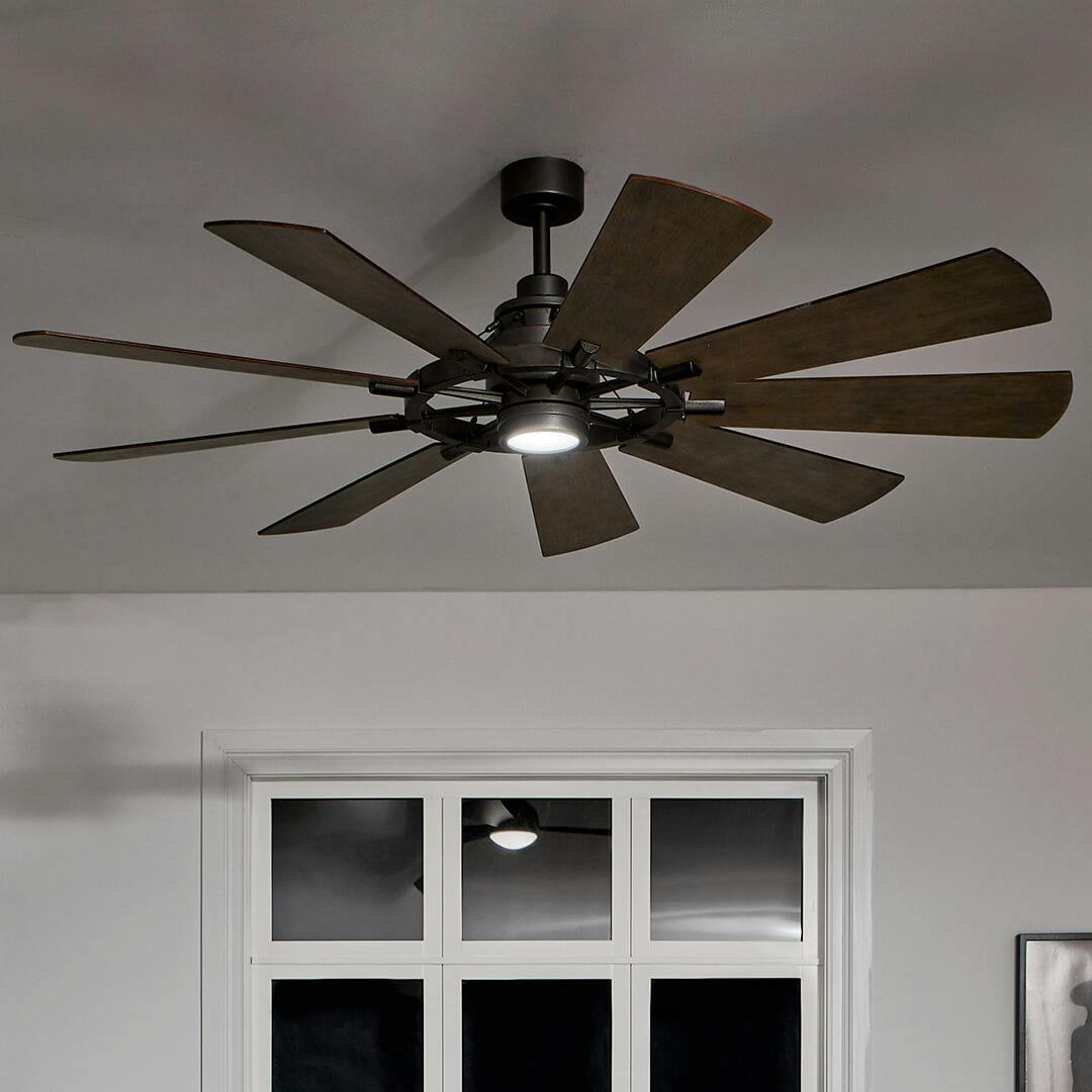 Night time Living room with Gentry LED 65" 9 Blade Fan in Anvil Iron