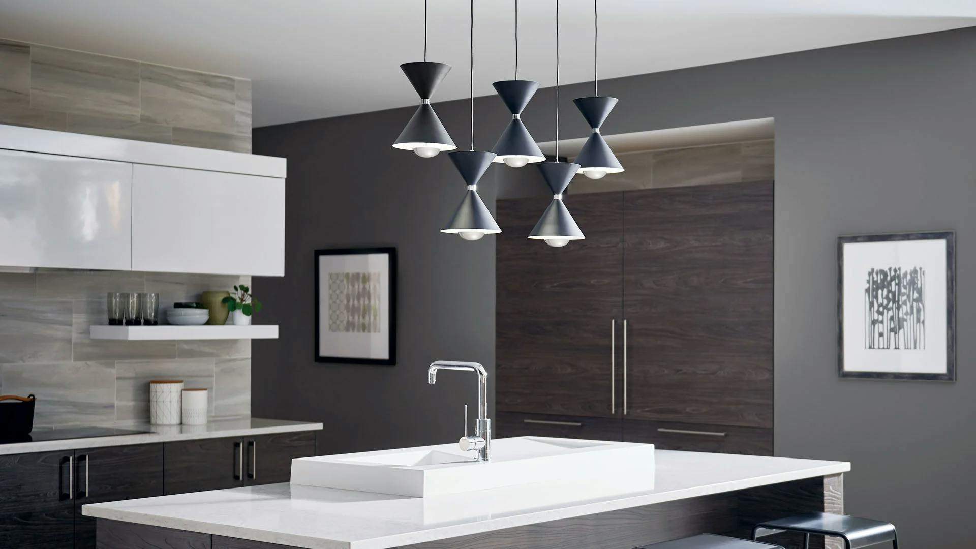 Modern kitchen during the day featuring a cluster of five kordan pendants in black over a kitchen island.