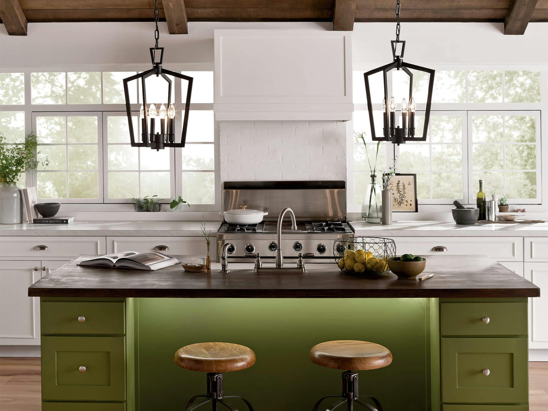 2 Abbotswell 19in 4 light pendants hanging over green kitchen island