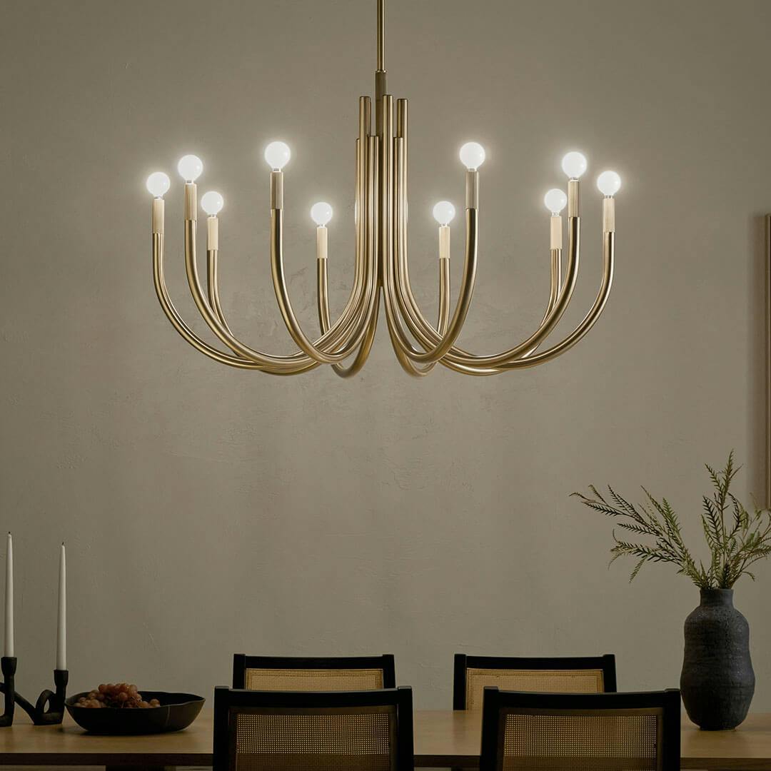Night time dining room with the Odensa 40.25 Inch 10 Light Chandelier in Champagne Bronze