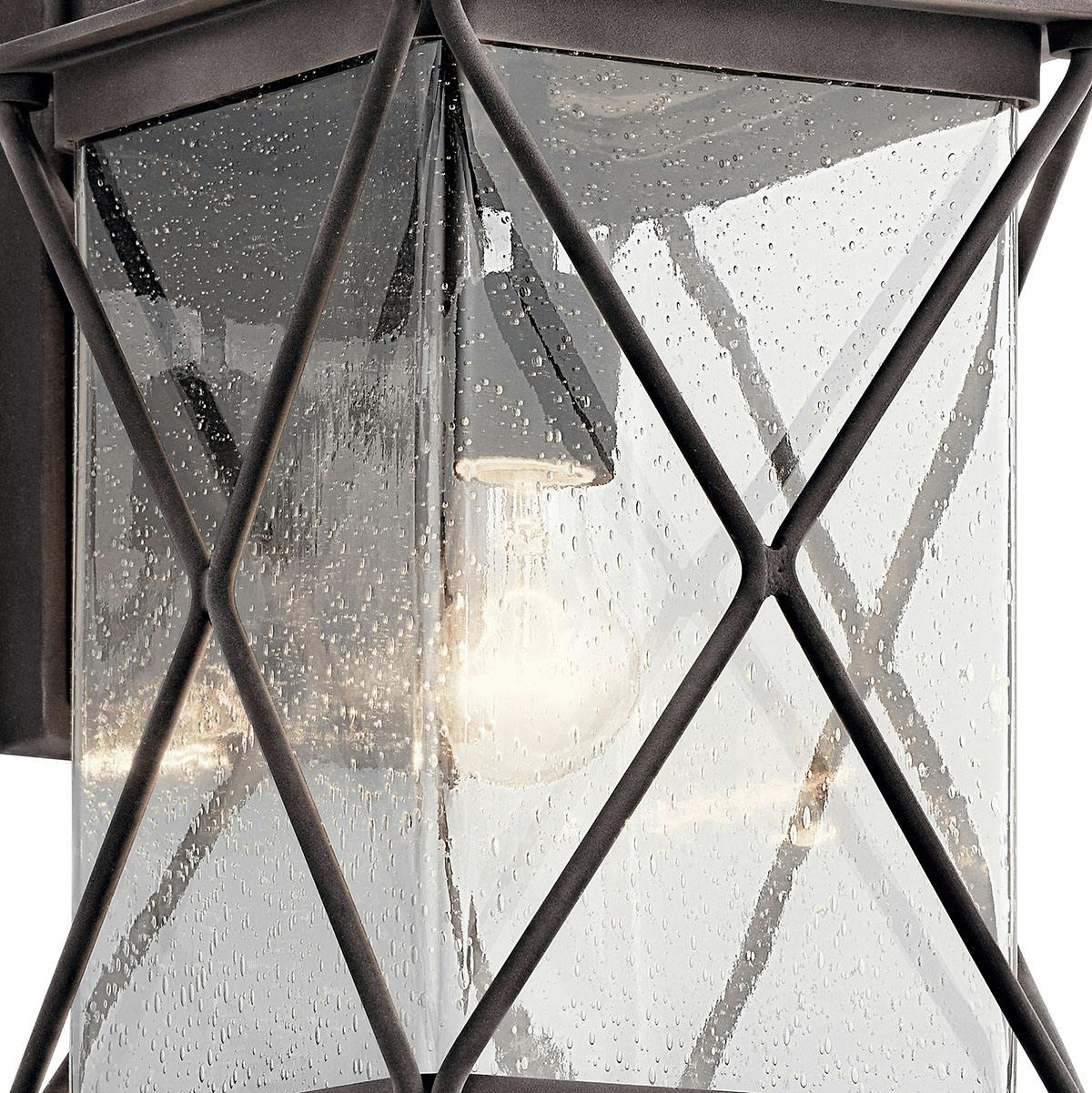 Close up view of the Argyle Wall Light - Seeded Glass in Zinc on a white background
