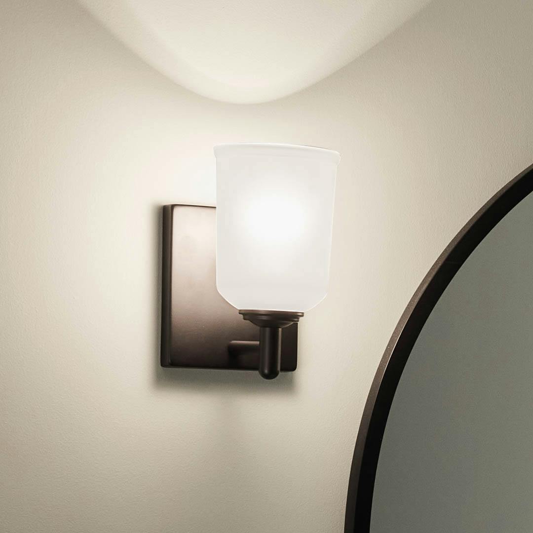 Night time bathroom with Shailene 8.25 inch 1 Light Wall Sconce with Satin Etched Glass in Black