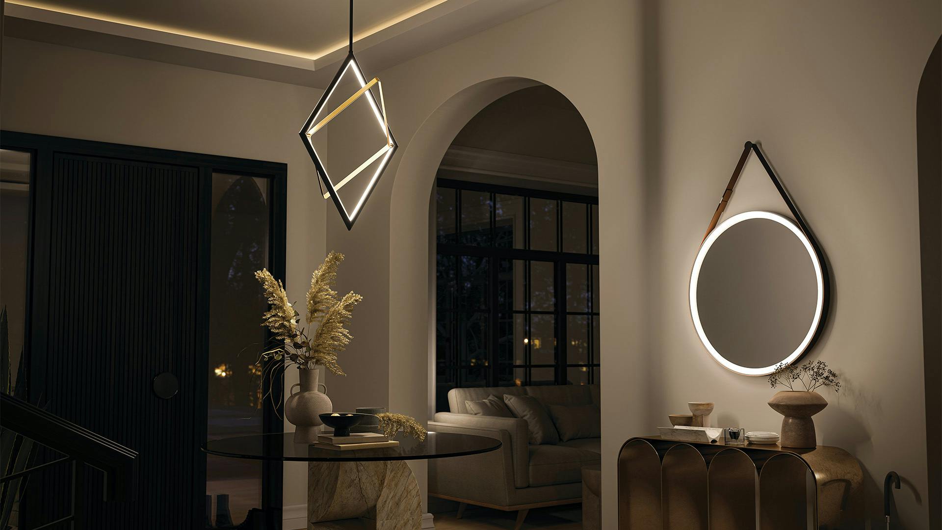 An interior entryway or foyer at night featuring a darski diamond pendant and round LED mirror on a wall.