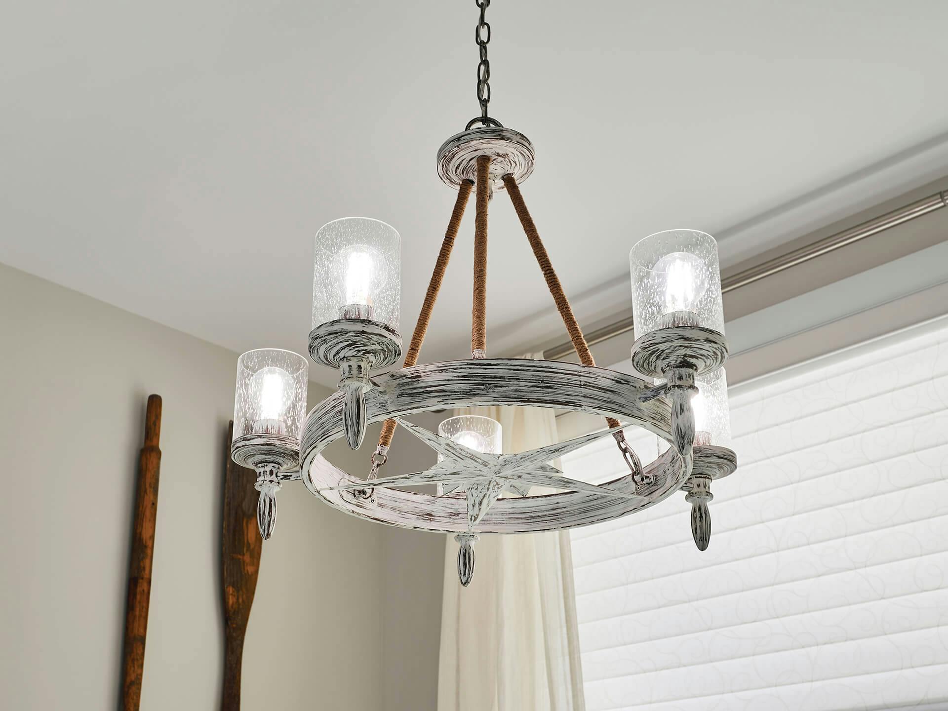 Close up of a minnow chandelier in a white dining room space