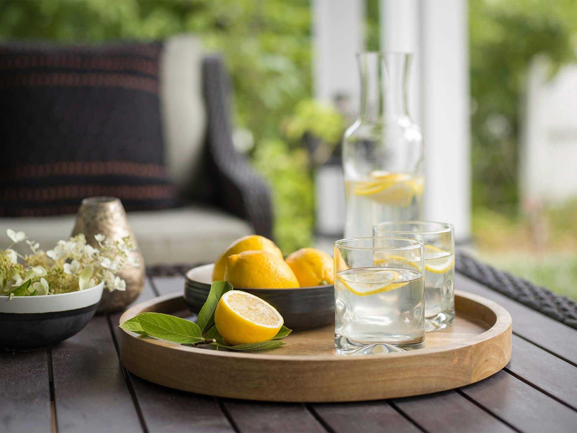 Patio lifestyle with lemons and drinks on table.
