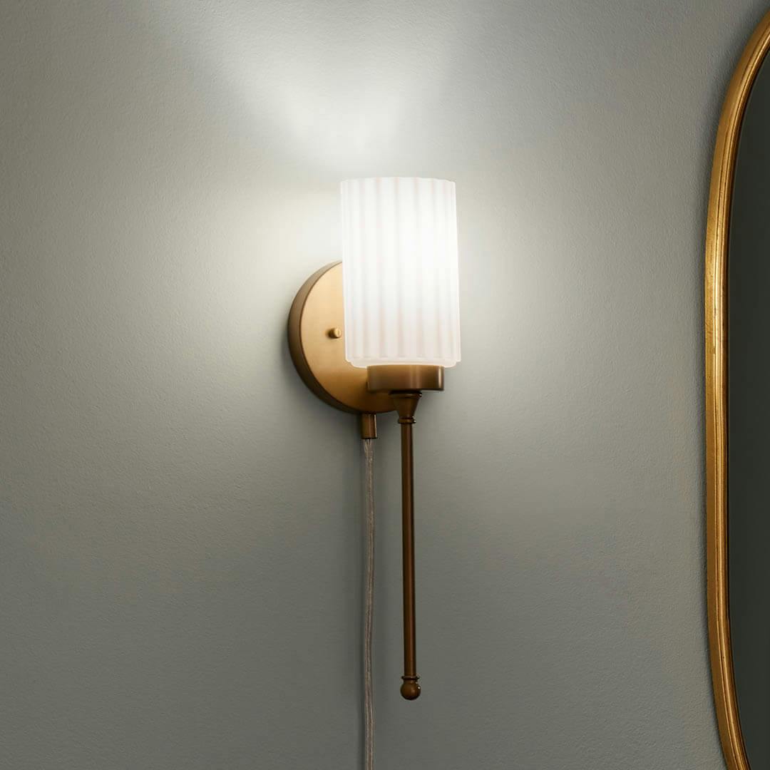 Night time dressing room with Thelma 16 Inch 1 Light Plug-In Wall Sconce with Satin-Etched Cased Opal Glass in Natural Brass