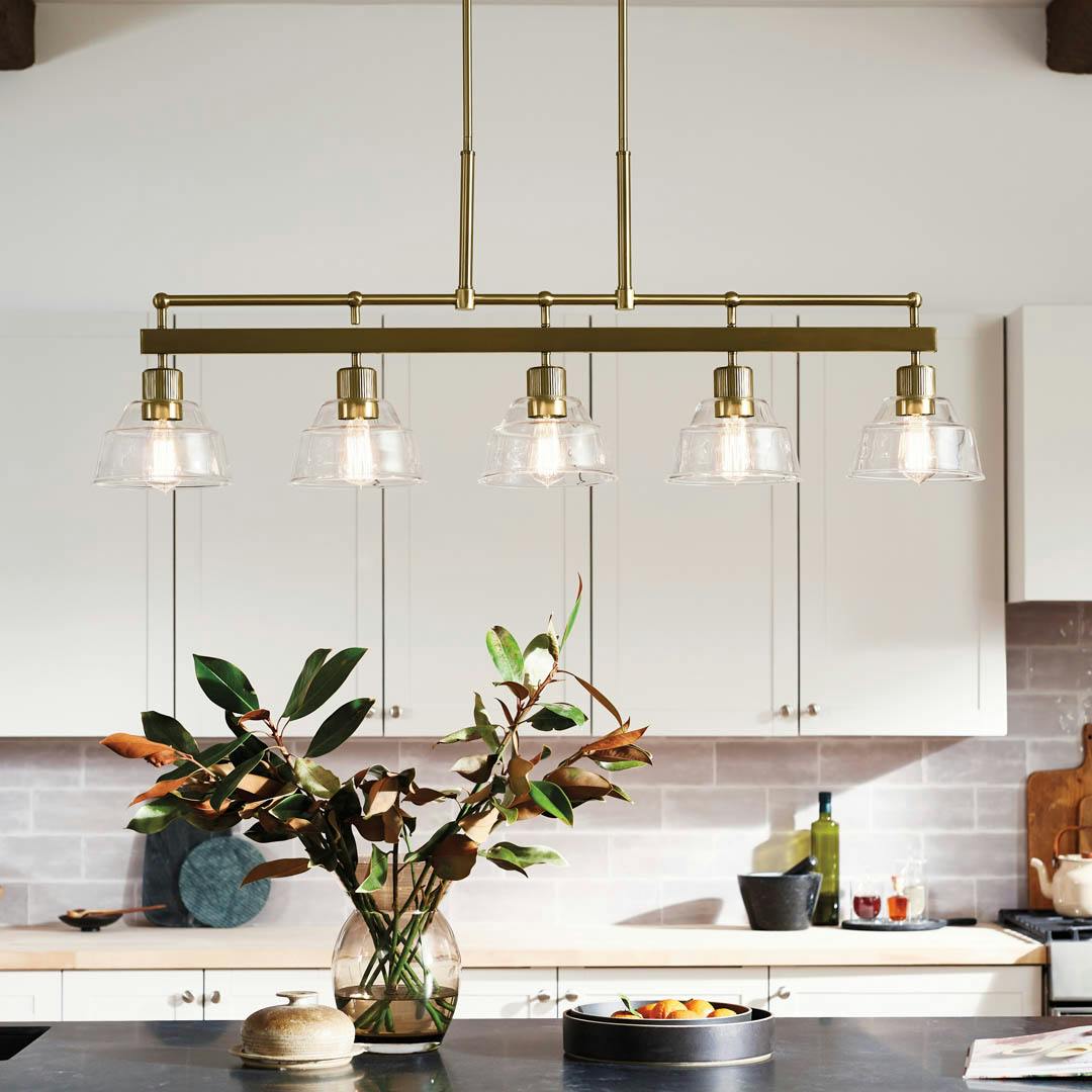 Day time kitchen with Eastmont™ 5 Light Linear Chandelier Brushed Natural Brass and Walnut Wood