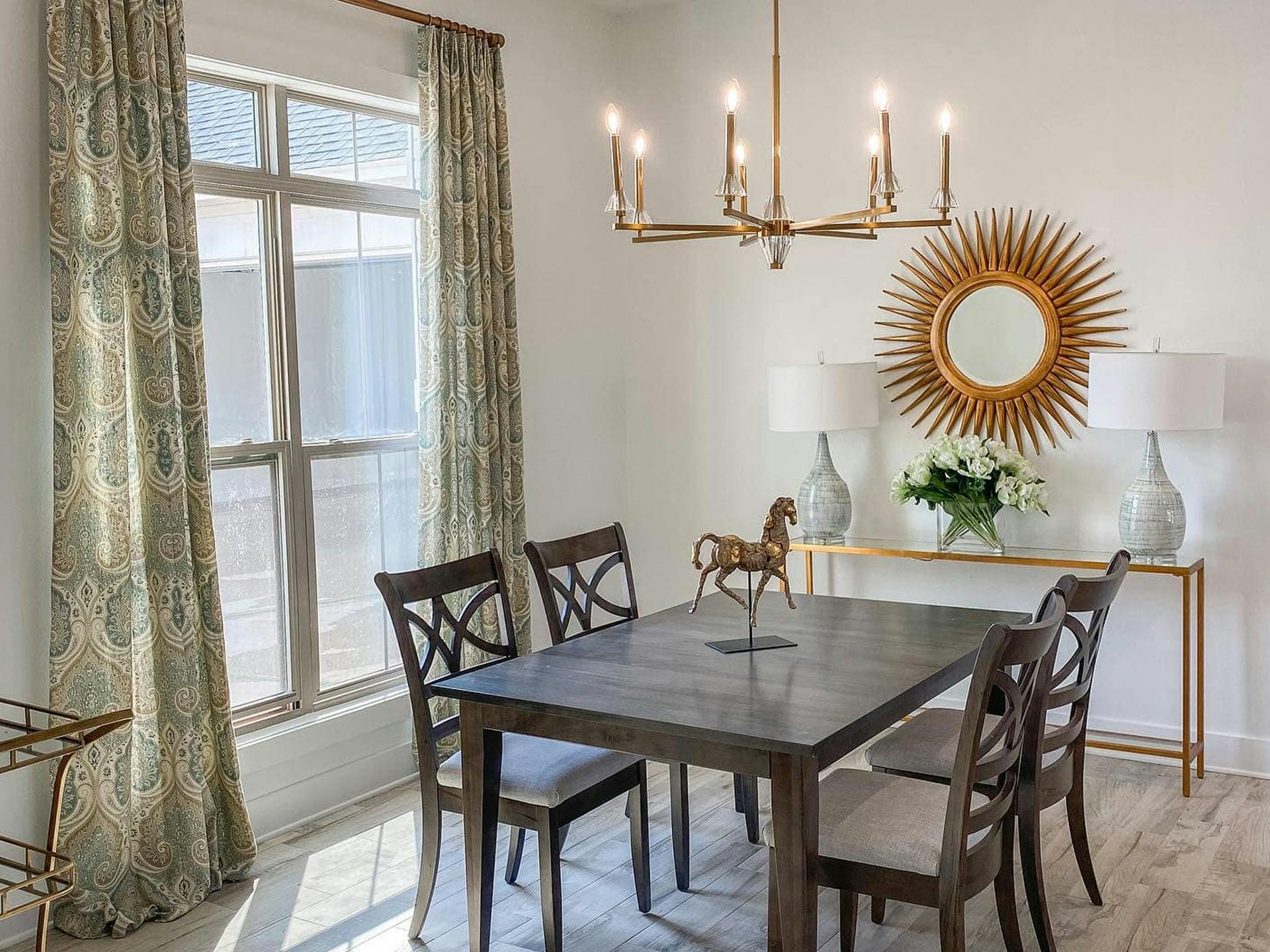 Dining room table with Kichler chandelier hanging overhead
